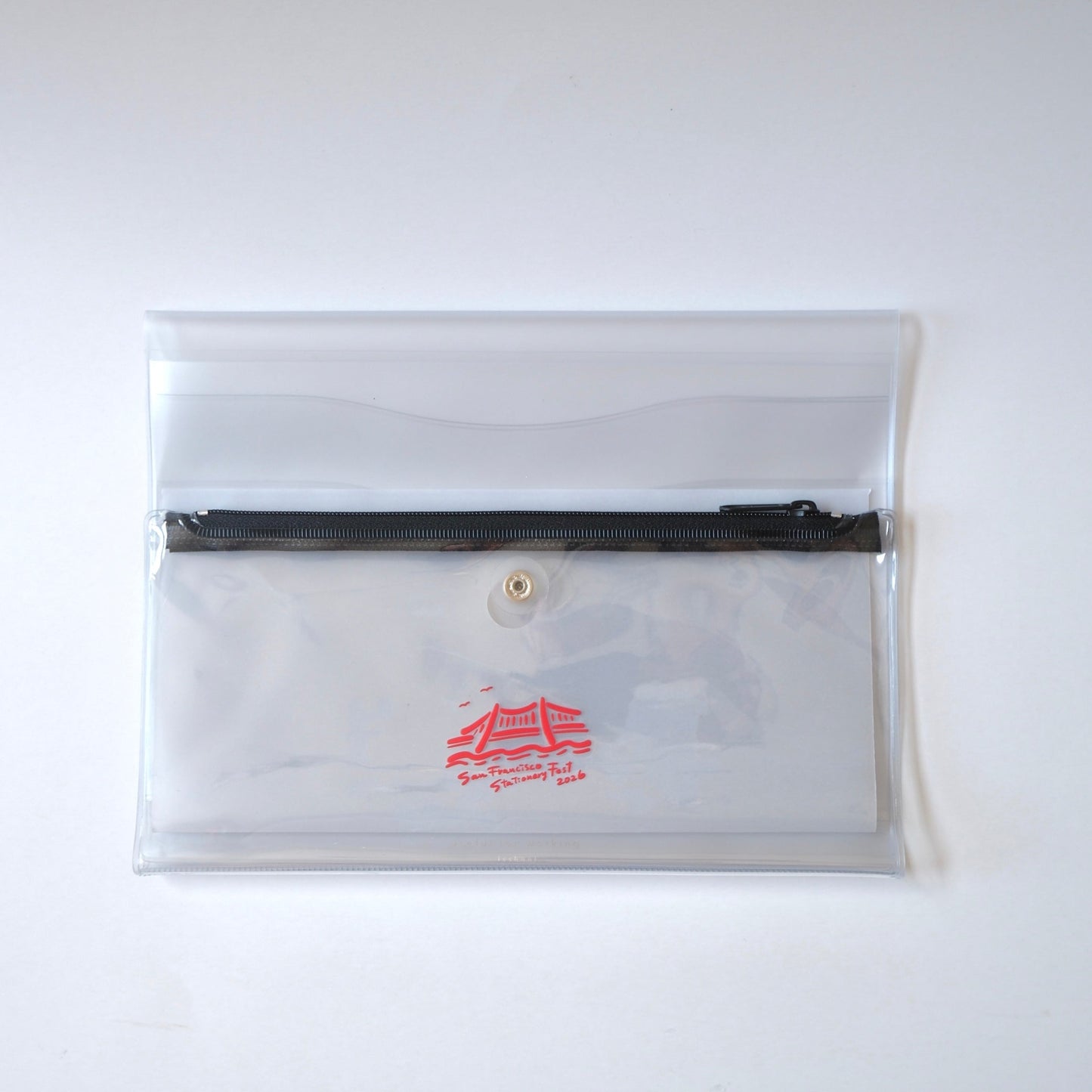 Clear pouch with a black zipper on a white background