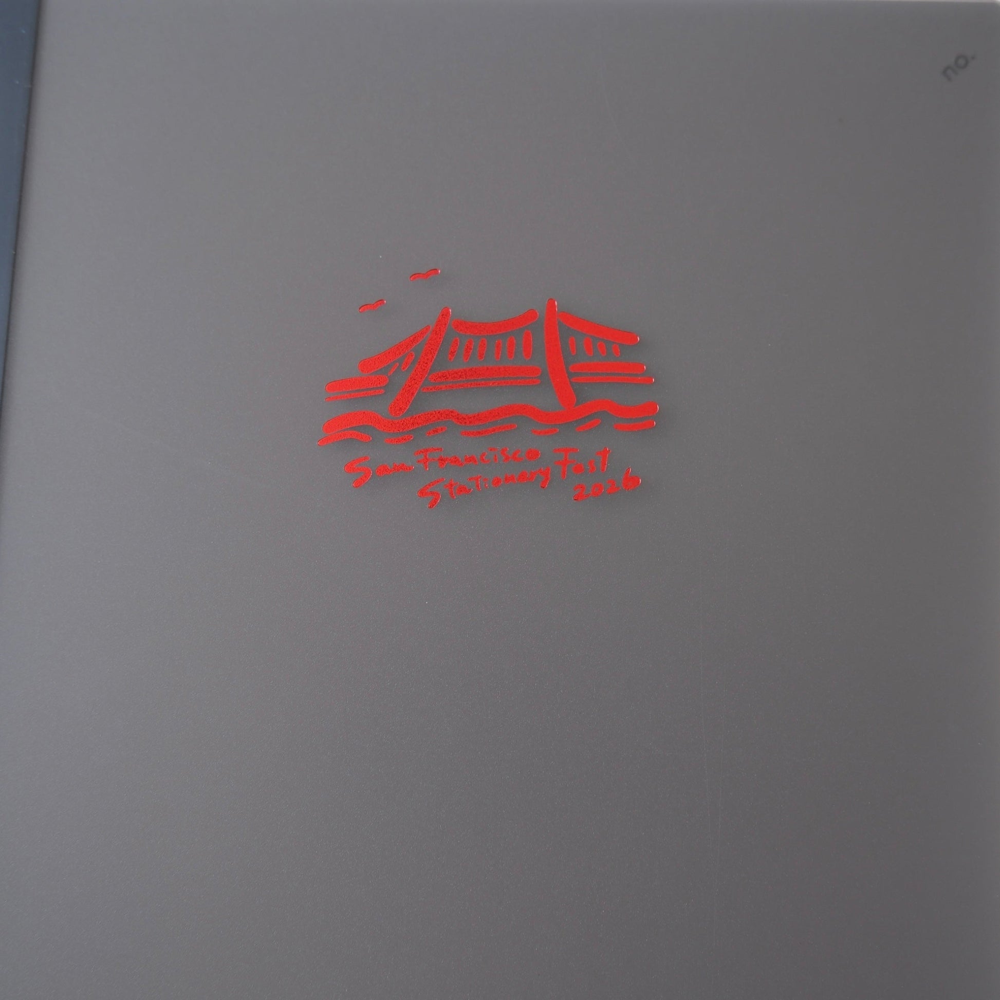 Gray book with red logo on a white background