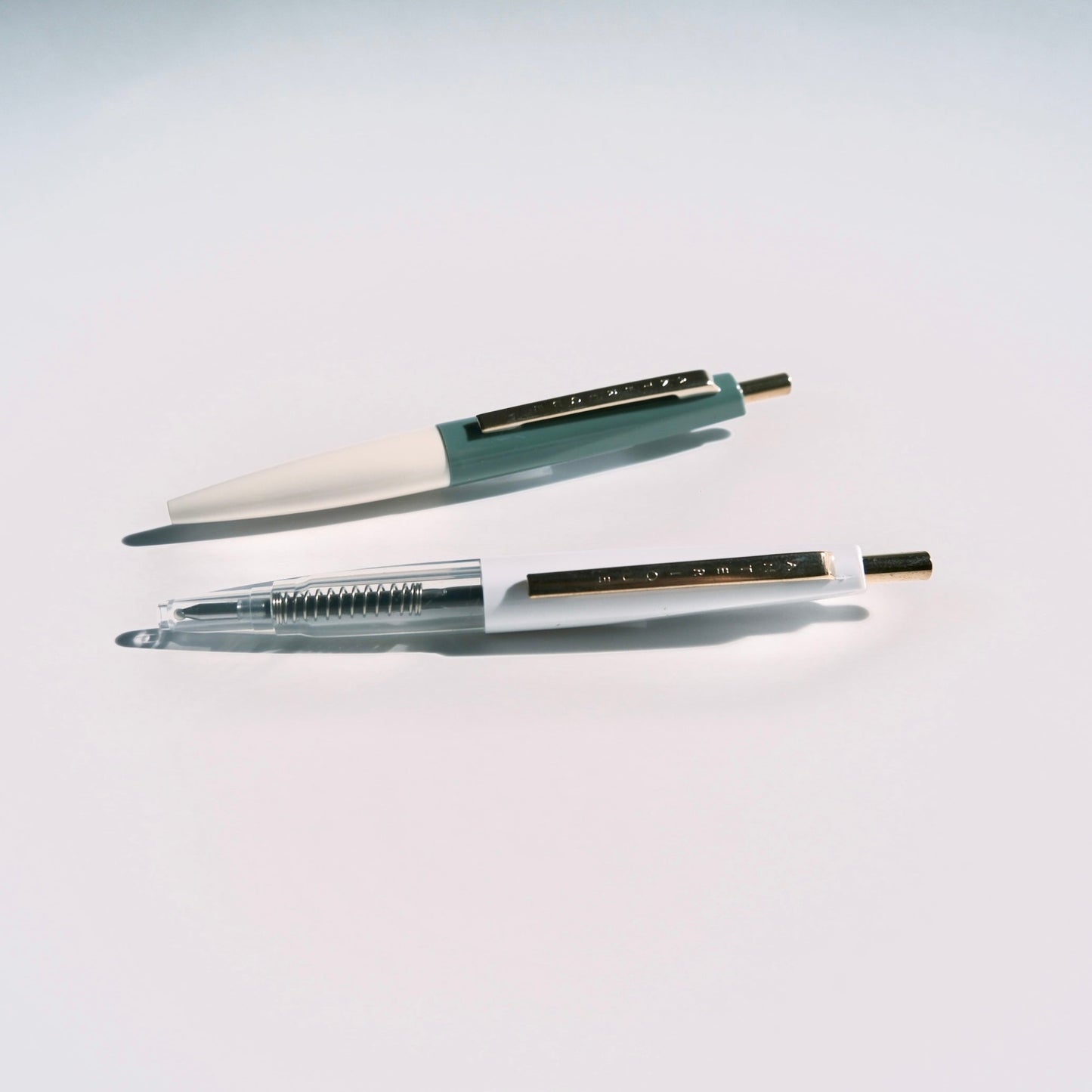 Two pens on a light gray background