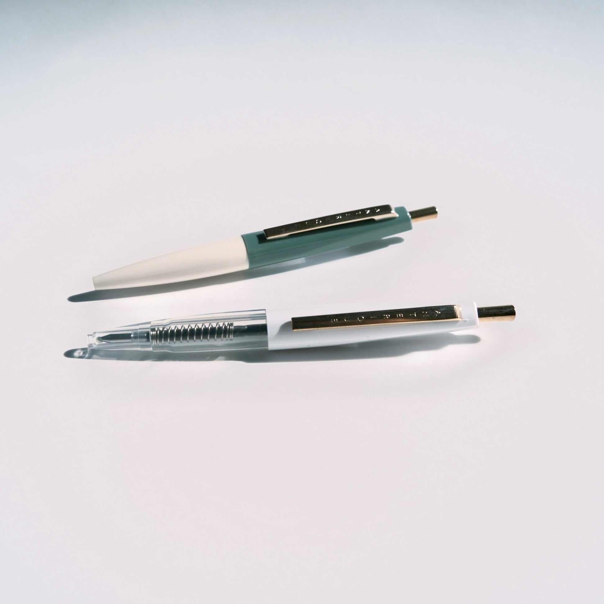 Two pens on a light gray background