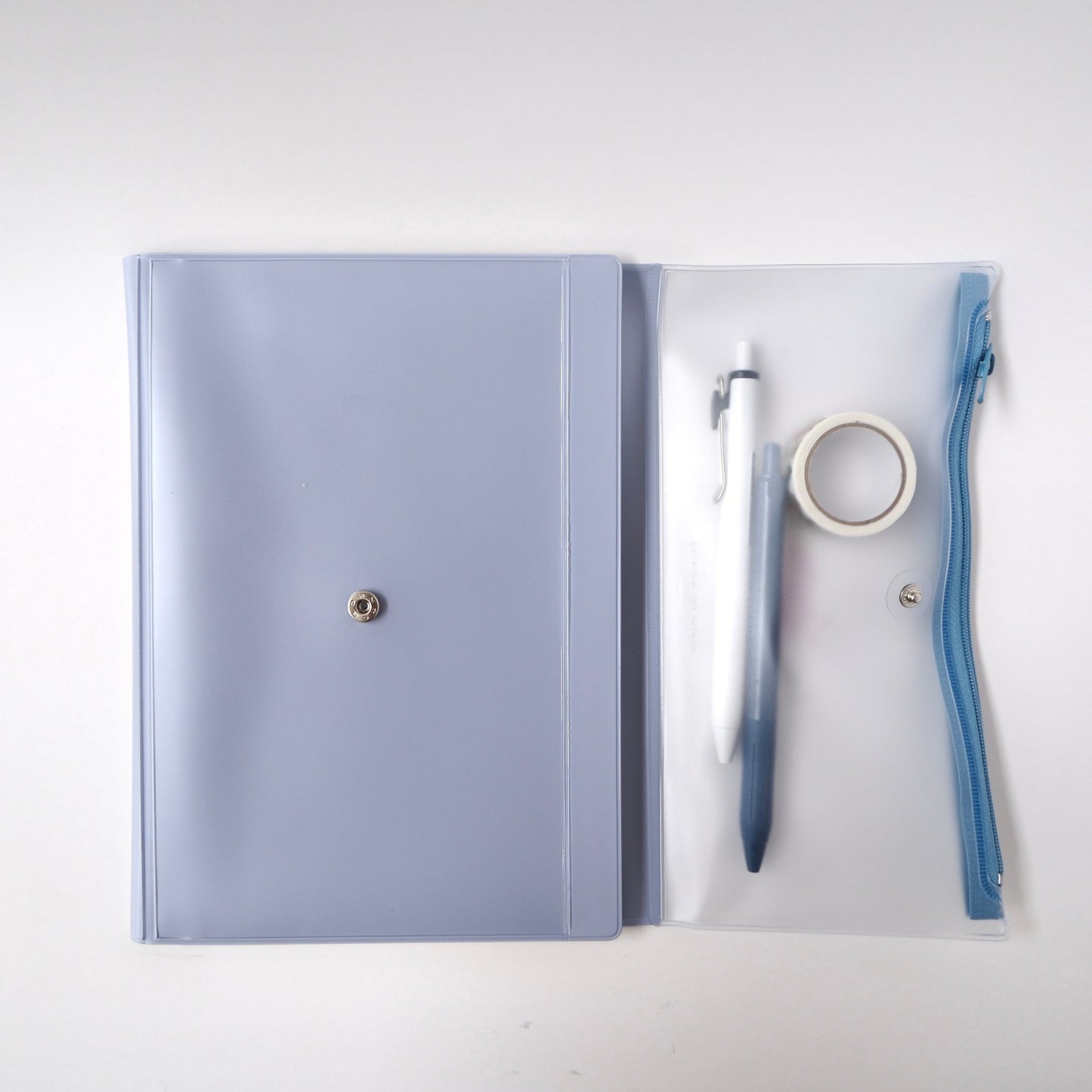 Open notebook cover with stationery accessories inside pen pouch