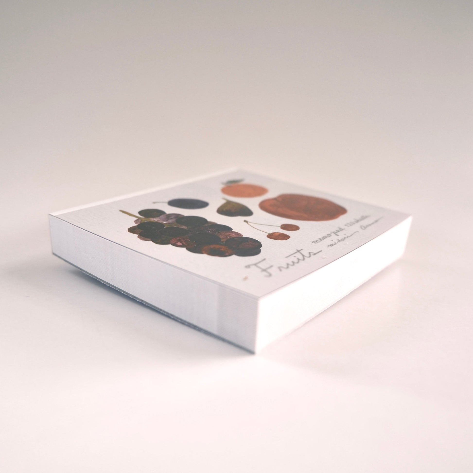 White memo block asano midori with abstract design on a light gray background