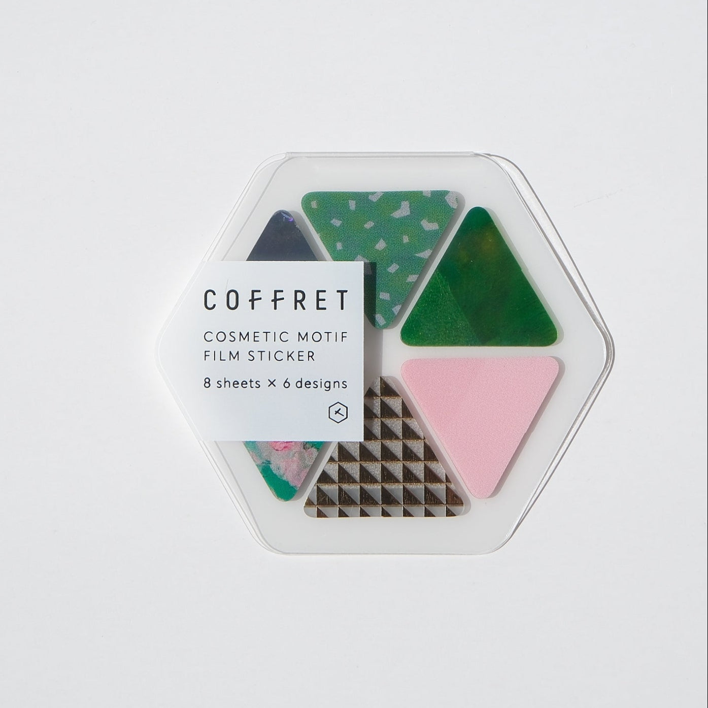 A hexagonal Coffret cosmetic stamp set containing four patterned stamps in green, pink, black, and white, shown on a plain white background.