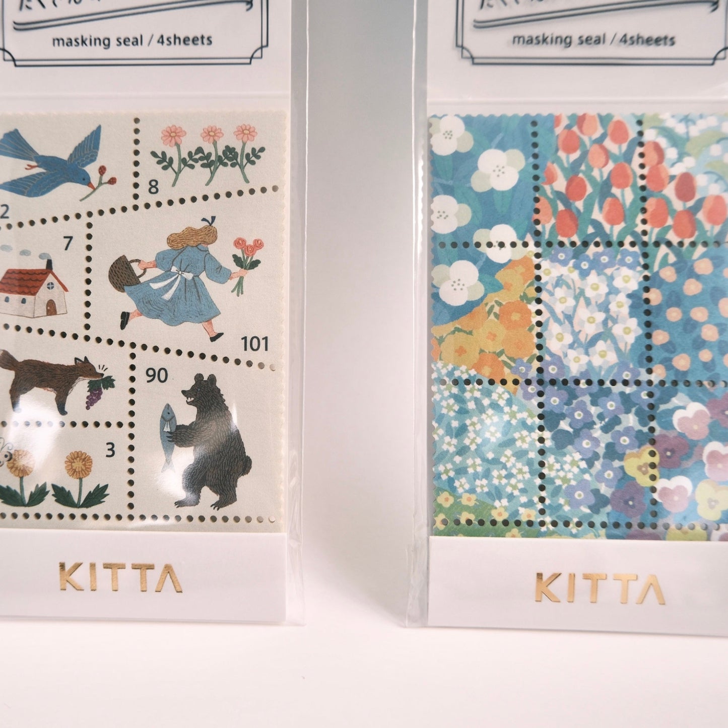 Two packages of KITTA masking seals with illustrated designs on a white background