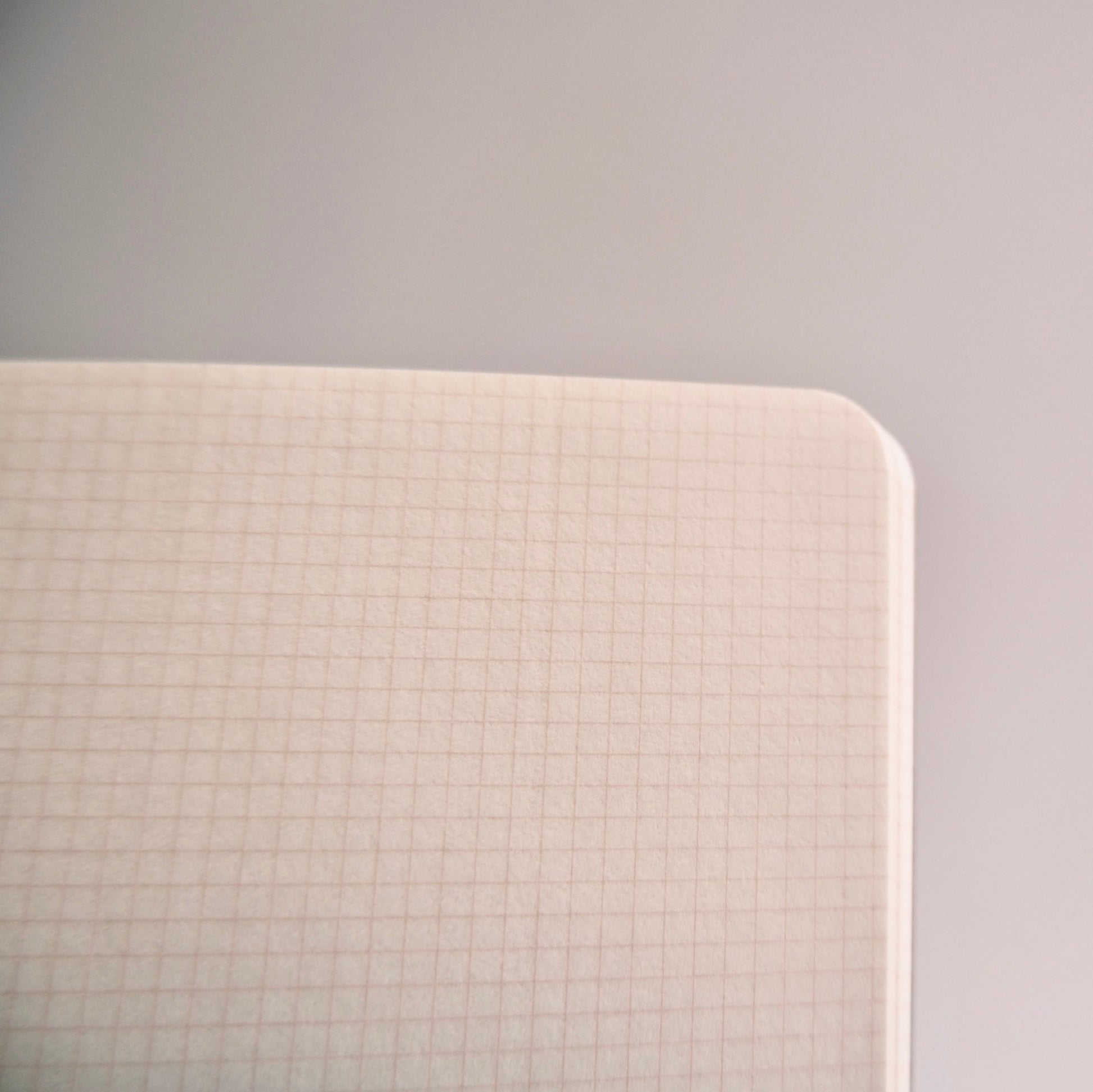 Close-up of Kleid B6 notebook interior showing subtle grid lines designed for organized writing and journaling.