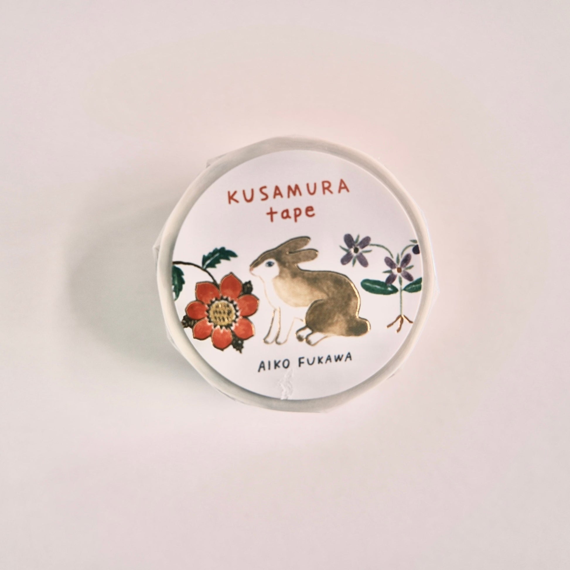 Round masking tape design top with rabbit and flower design on a white background